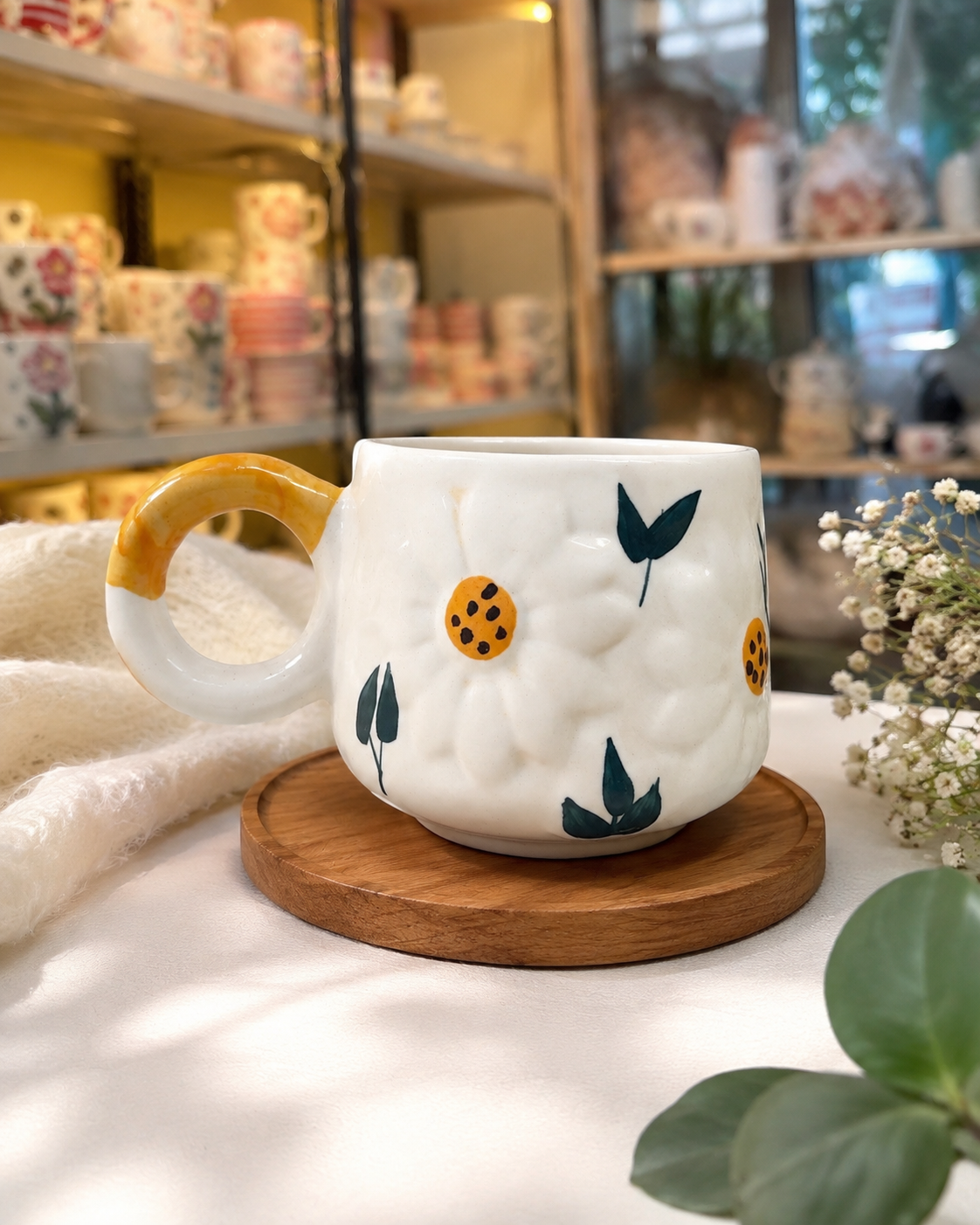 Handmade white ceramic floral mug with yellow handle