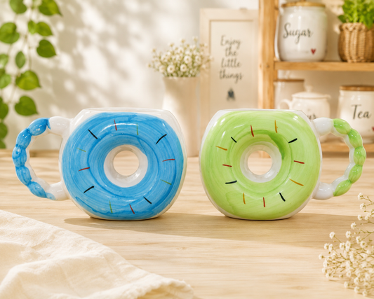 Blue and green donut-shaped ceramic mugs