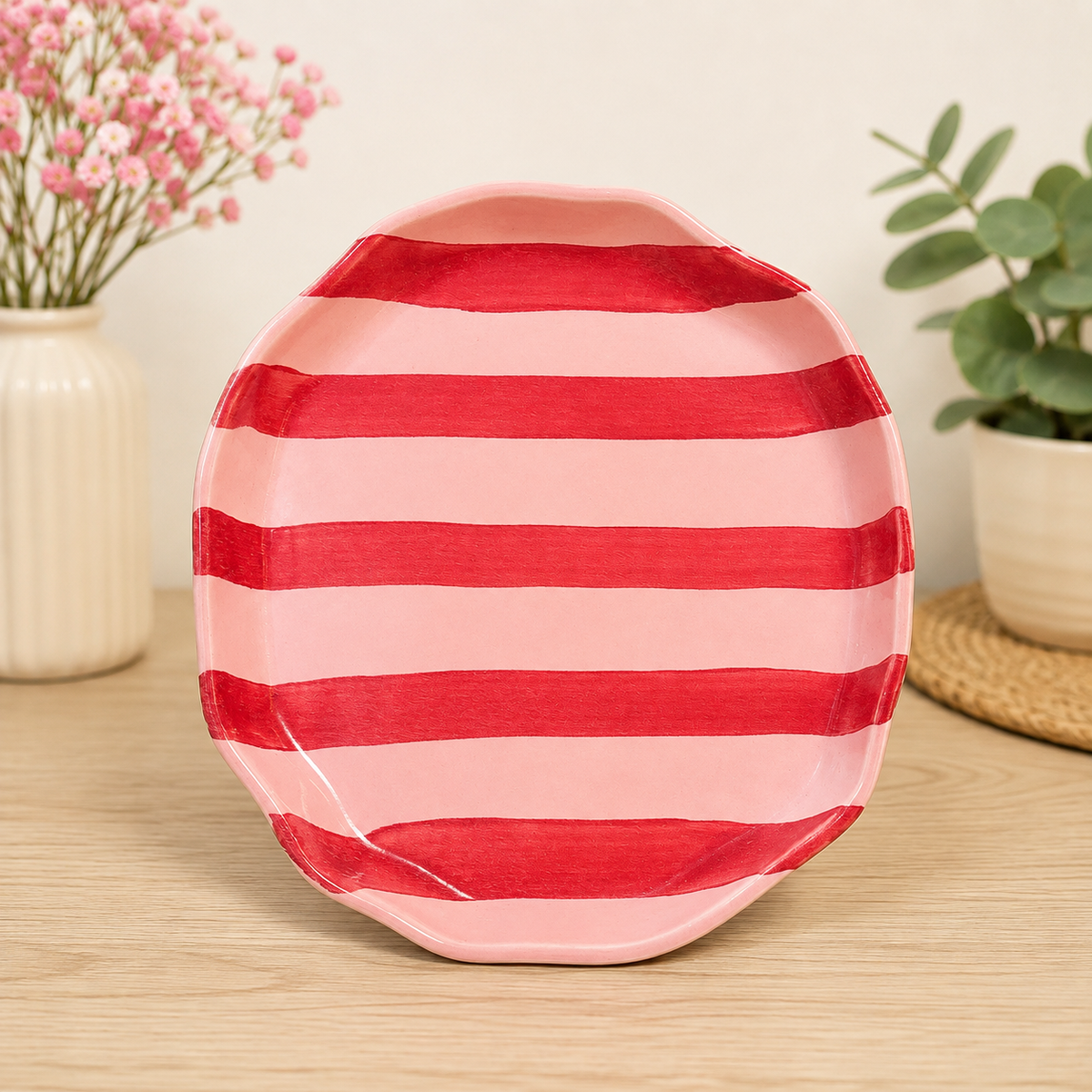 Pink ceramic plate with red horizontal stripes