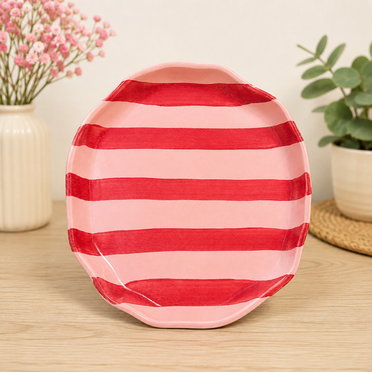 Pink ceramic plate with red horizontal stripes