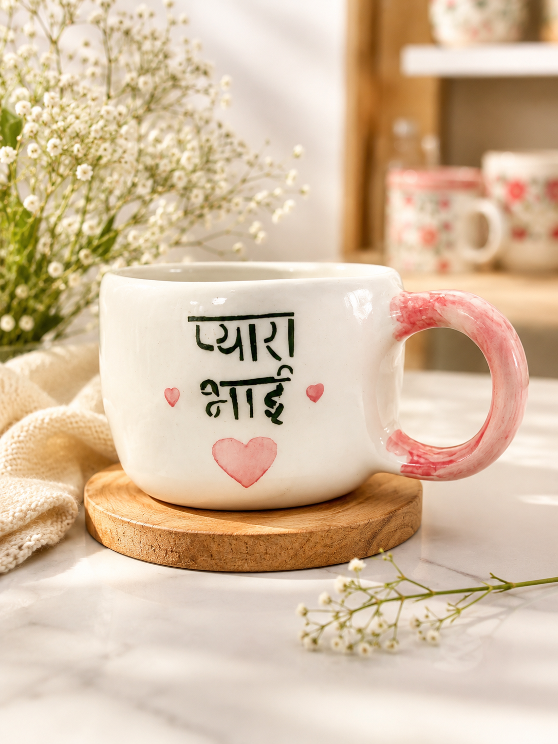 White ceramic Pyara Hai mug with pink marbled handle