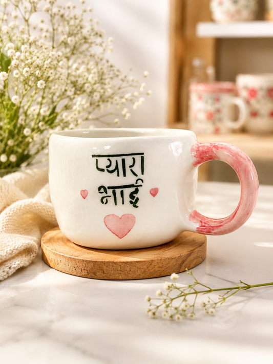 White ceramic Pyara Hai mug with pink marbled handle