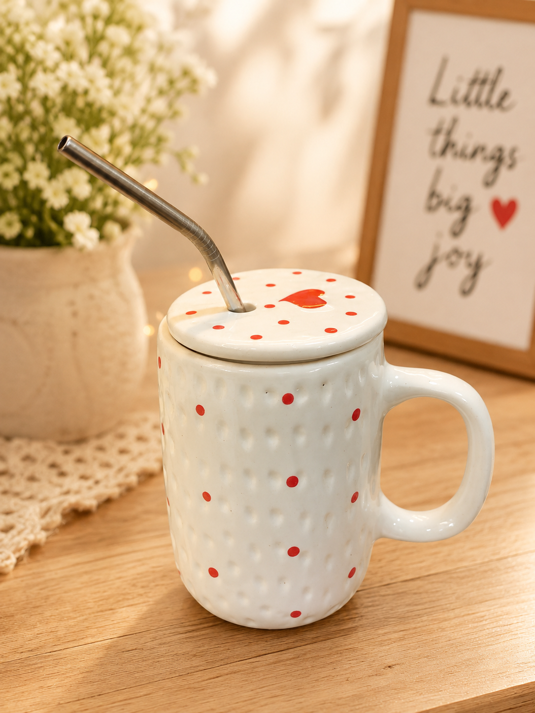 White ceramic mug with red polka dots, heart lid and stainless steel straw
